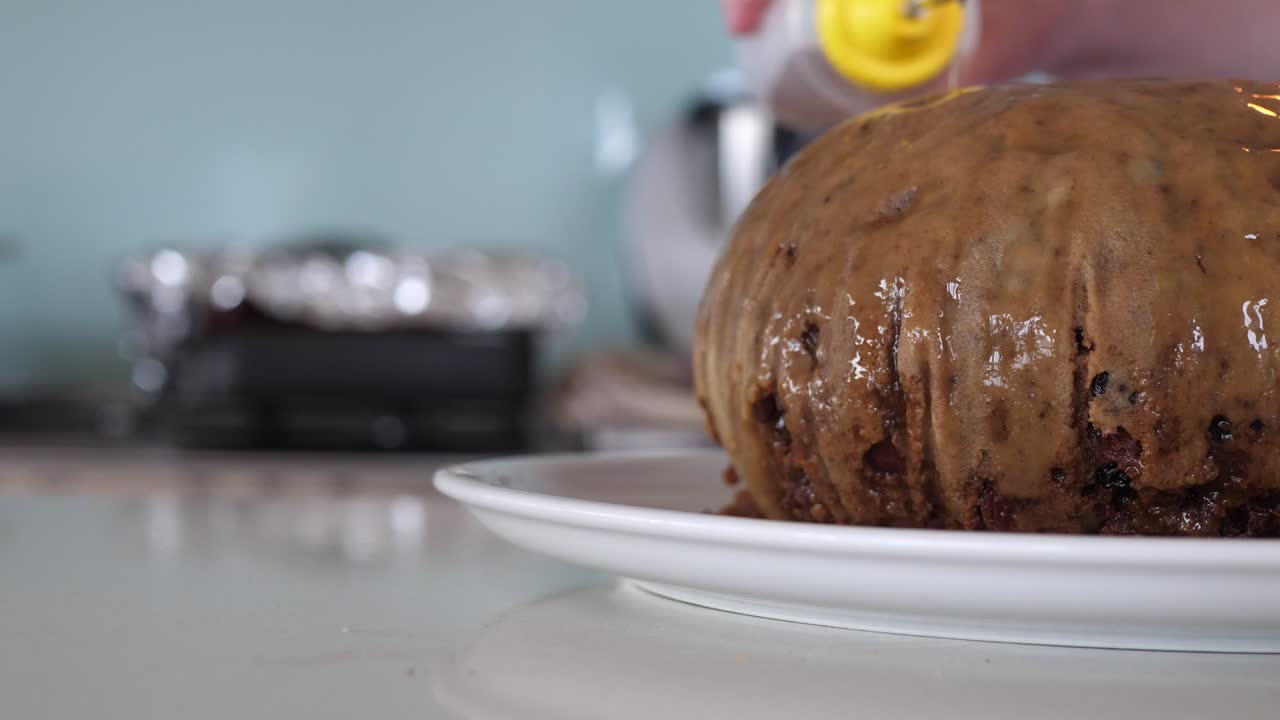 Pouring Alcohol Over Christmas Pudding And Lighting With A Match