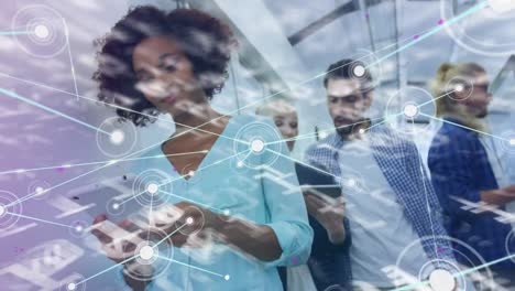 animation of data processing and network of connections over diverse business people using tablets