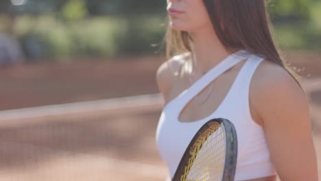 female tennis player practicing serve on outdoor court