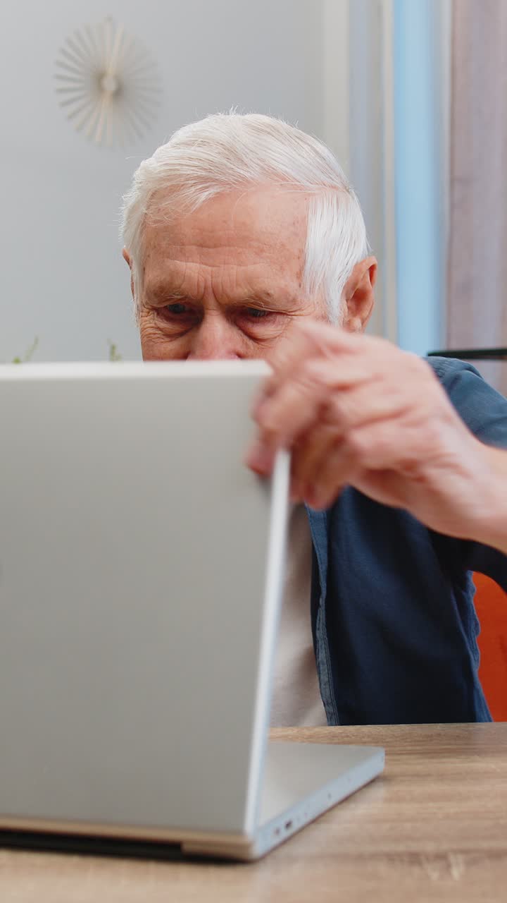 Unhappy sad senior elderly man use laptop bad news fortune loss game fail lottery results at home