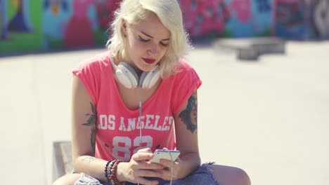 young woman searching for tunes on her mobile