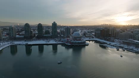 vancouver science world astc building covered in winter snow - drone aerial sunset shot