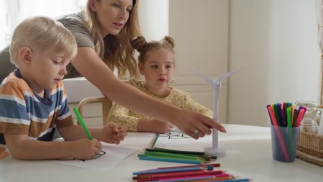 video of children coloring a recycle symbol