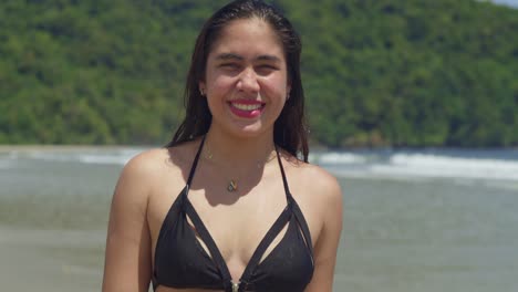 a tropical beach setting features a young woman with confidence, donned in a stylish thong bikini walking in the sand