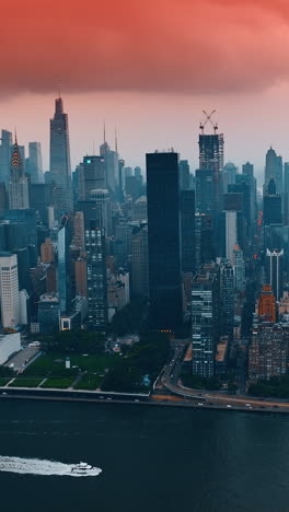 pink cloudscape accumulated above manhattan. scenery of new york architecture at sunset. top view. vertical video