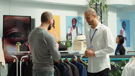 customer interacting with sales associate in a men's clothing store