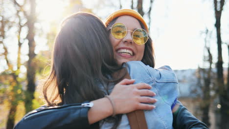 Close-up-view-of-happy-hipster-group-of-friends-greeting-and-hugging-in-the-park-in-autumn