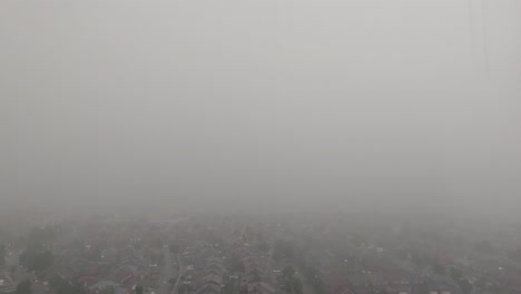 High-Angle-Time-lapse-Of-Heavy-Rain-Downpour-Over-Suburban-Town-With-Overcast-Moody-Clouds-Going-Past