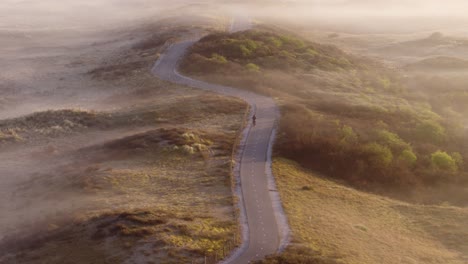 misty morning cycle path through dunes