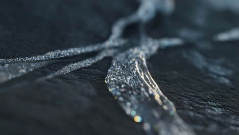 abstract water flow on a textured dark surface