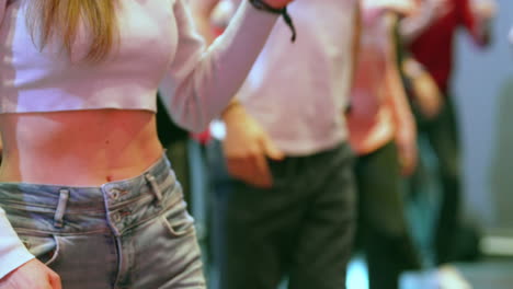 slow motion captures a young woman's torso dancing with energy
