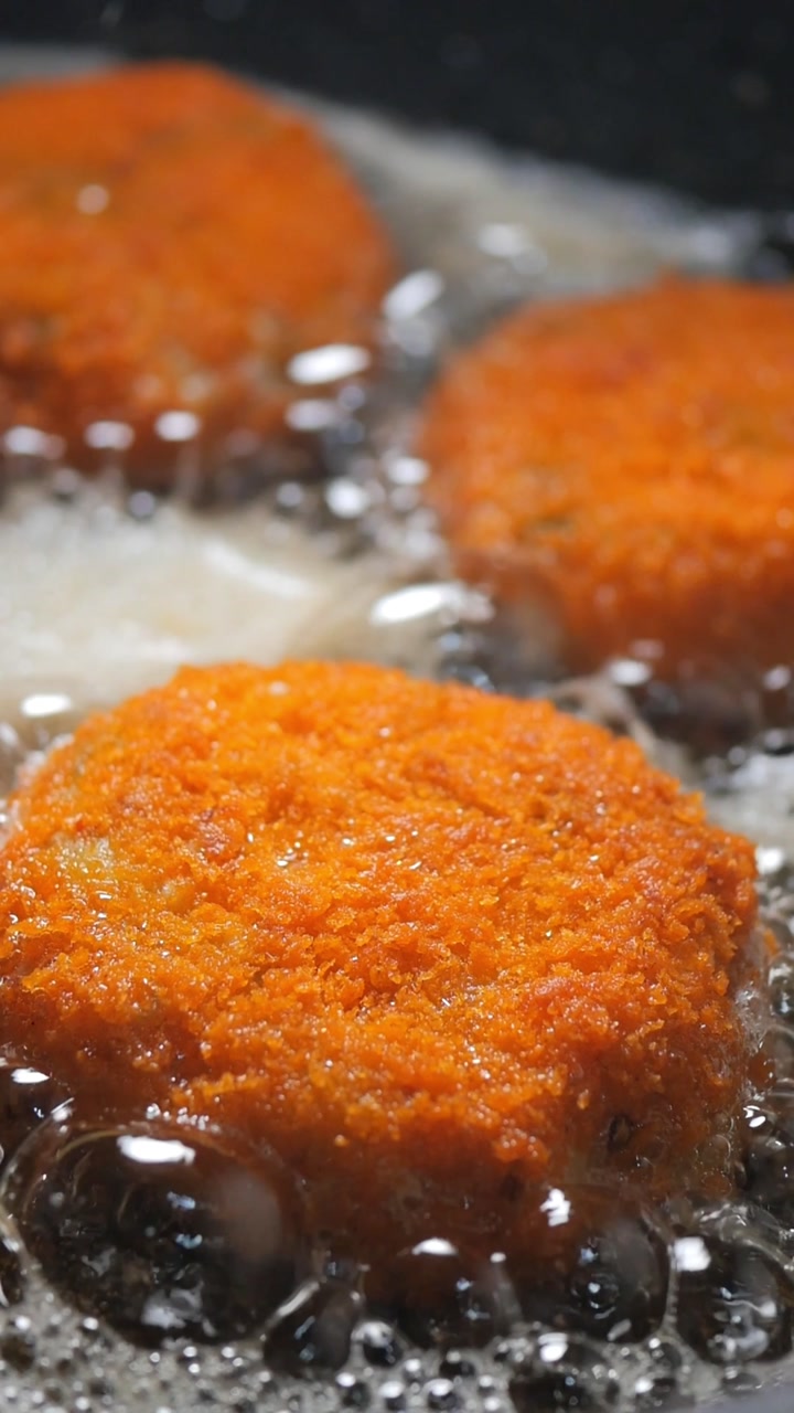 Delicious Breaded Patties Frying to Golden Brown in Hot Oil