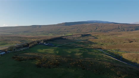 establishing aerial shot of ribblhead viaduct and whernside in winter