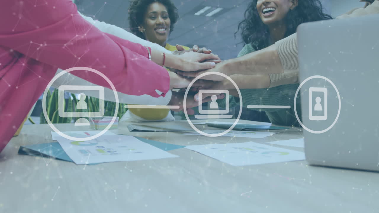 Animation of icons and data processing over diverse business people stacking hands in office