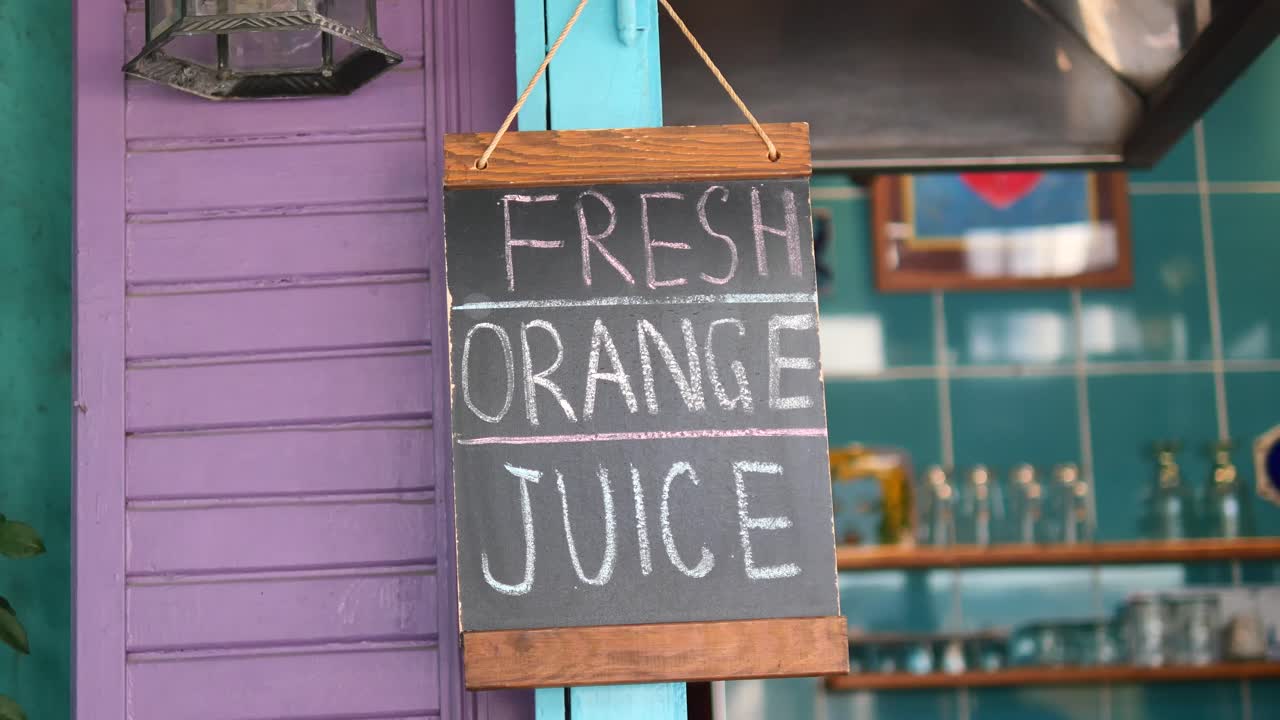 Fresh Orange Juice Sign at a Colorful Cafe