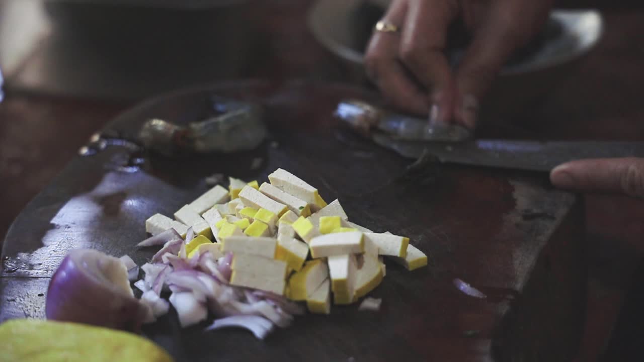 Cooking Pad Thai Series: SLO MO chef's hand deveining and cutting shrimp at Thai street food shop.