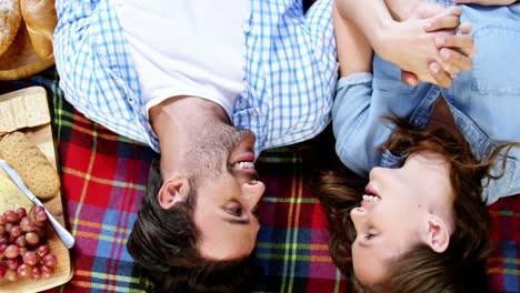 Couple-lying-on-picnic-blanket