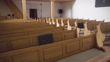 rows of pews inside small, empty reformed church