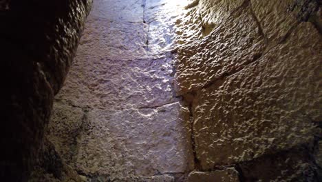 climbing up into narrow staircase with large stone blocks in belém tower, lisbon, portugal