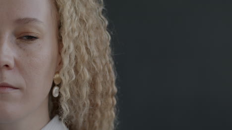 close-up portrait of a woman with curly blonde hair