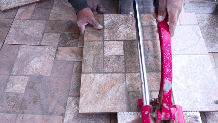 Construction men worker builder cutting tiles at home