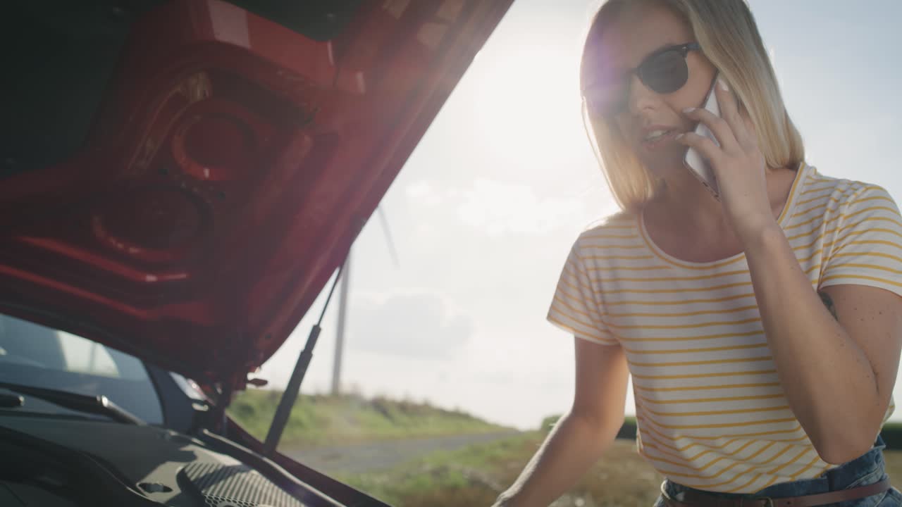 Video of woman calling her insurance after a car breakdown