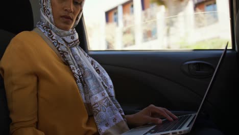 young woman wearing hijab out and about in the city
