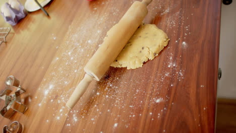 Baking-utensils-with-cookies-dough-lying-on-countertop-in-kitchen-at-home,-slow-motion