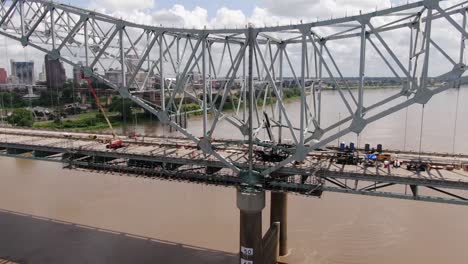 panning drone shot of construction work on hernando de soto bridge
