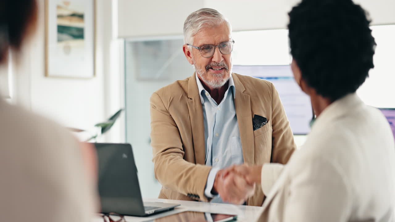 Business professionals shaking hands during a meeting