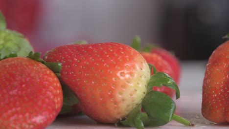 close on strawberries poured onto chopping board