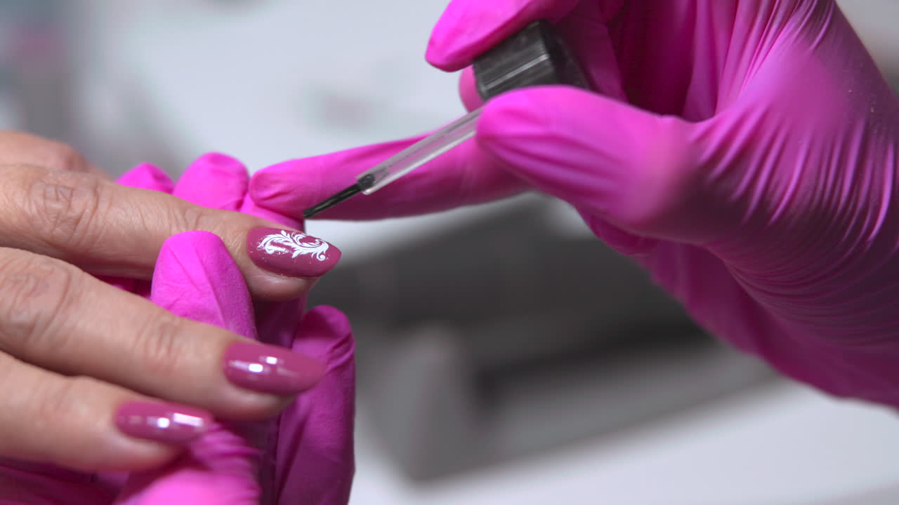 Manicure process with pink gloves and nail art design