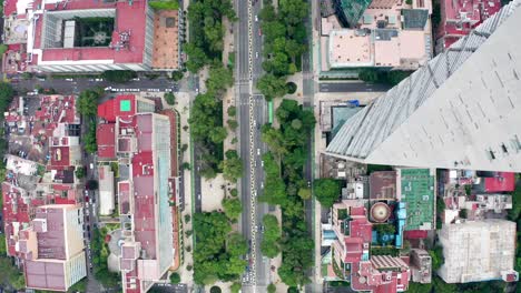 spectacular high aerial flight past tall torre mayor tower, chapultepec uno, bbva and reforma skyscrapers in downtown financial district directly above paseo de la reforma avenue, drone tracking