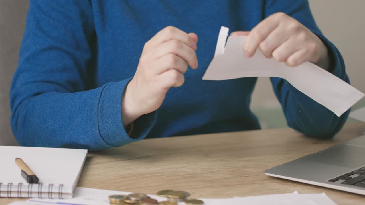 female hands opening envelope letter document or bills, reading, writing down