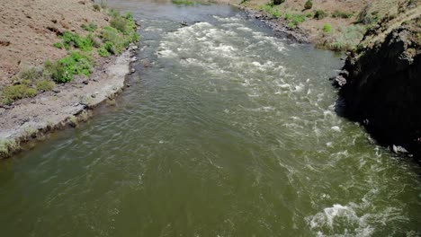 drone shot of a dad and his two daughters rafting down a class iii rapid call burnt ranch rapid