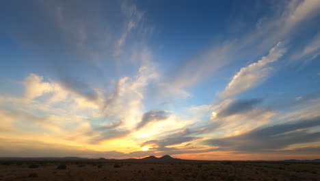 awe inspiring desert sunrise with the golden dawn breaking over the distant mountains - wide angle static time lapes