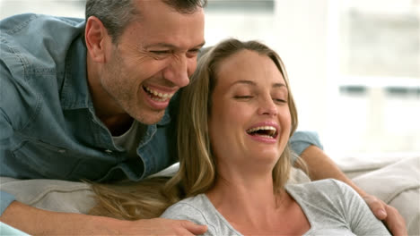 happy future parents using laptop and holding credit card