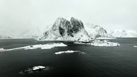 Scenic-white-winter-landscape-of-rugged-mountains-of-Lofoten-archipelago,-aerial