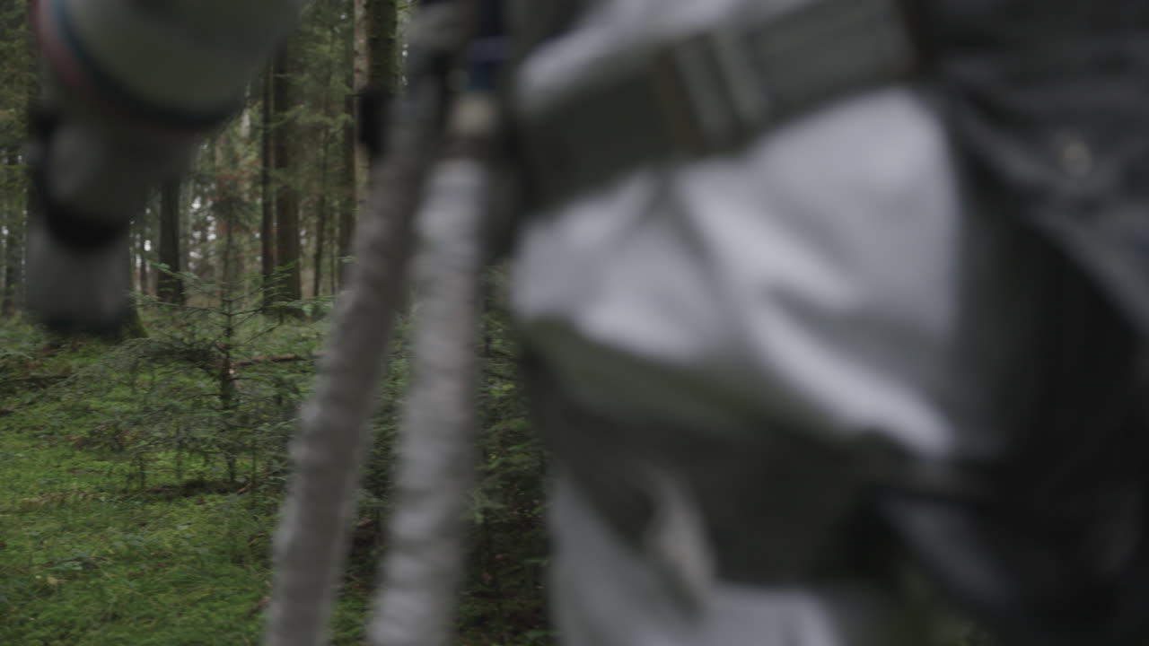 Astronaut in space suit walking trough forest