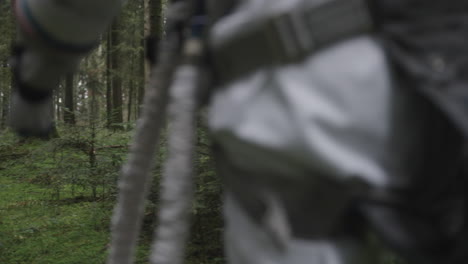 astronaut in space suit walking trough forest