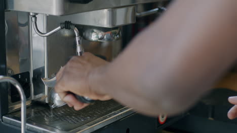 person making coffee with a coffee machine