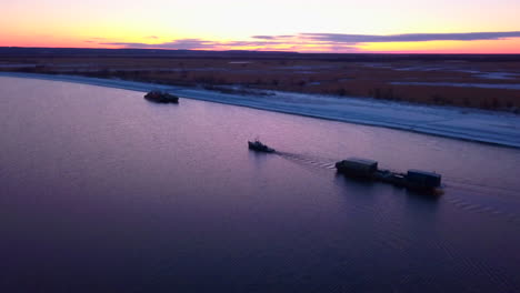 winter river sunset with tugboat and barge