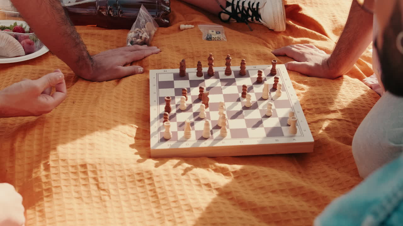 Friends Playing Chess at a Picnic