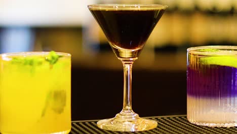 vibrant drinks displayed on a bar counter