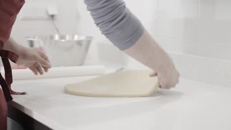 an early stage of rolling out the dough for butter cookies in an artisan pastry shop, 4k