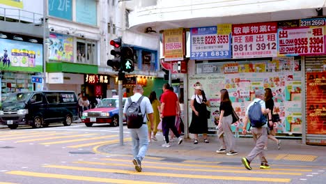 people crossing street at a busy intersection