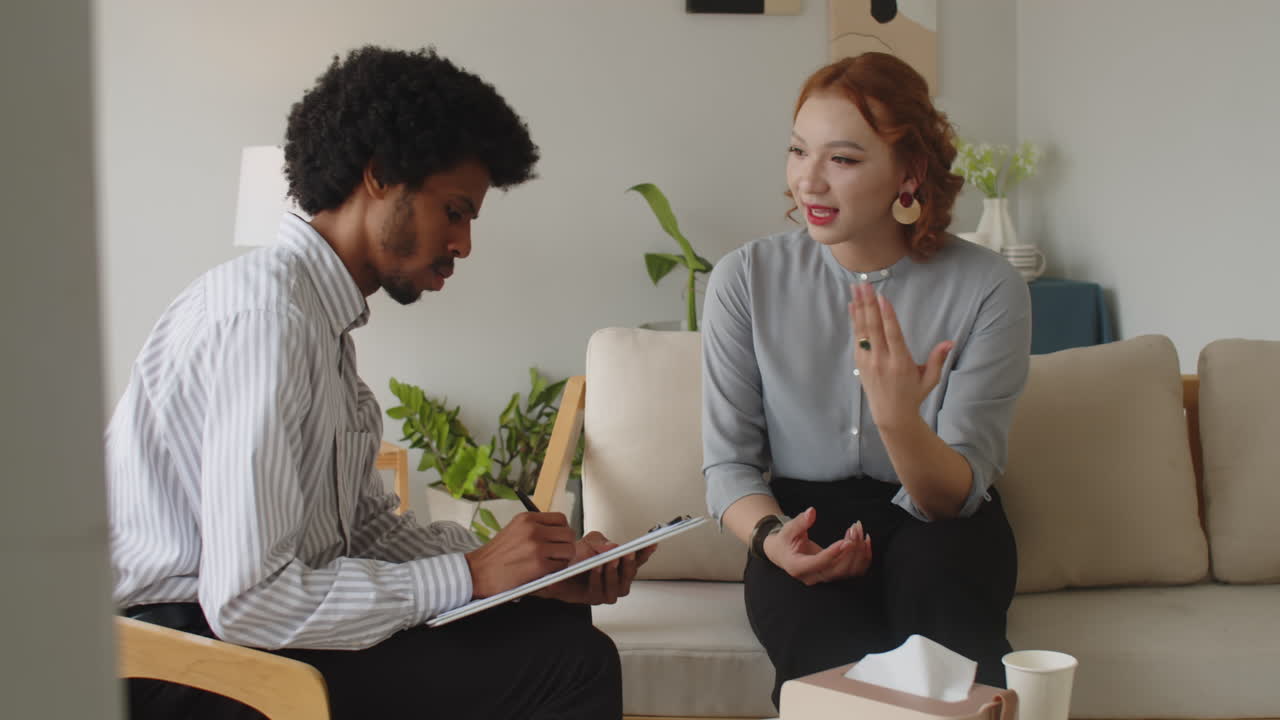 Psychotherapist Filling Form when Listening to Patient Talking about Stress