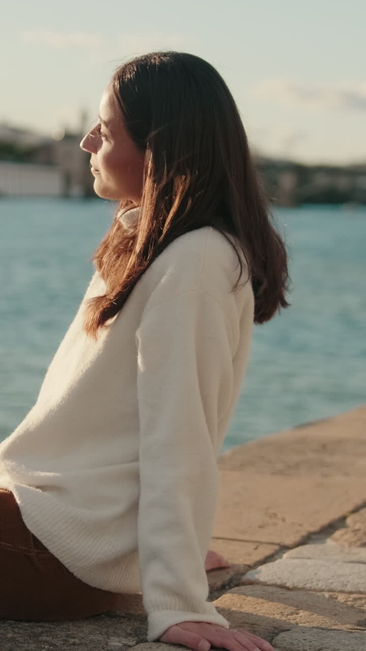 Woman Enjoys Seville Riverside Sunset