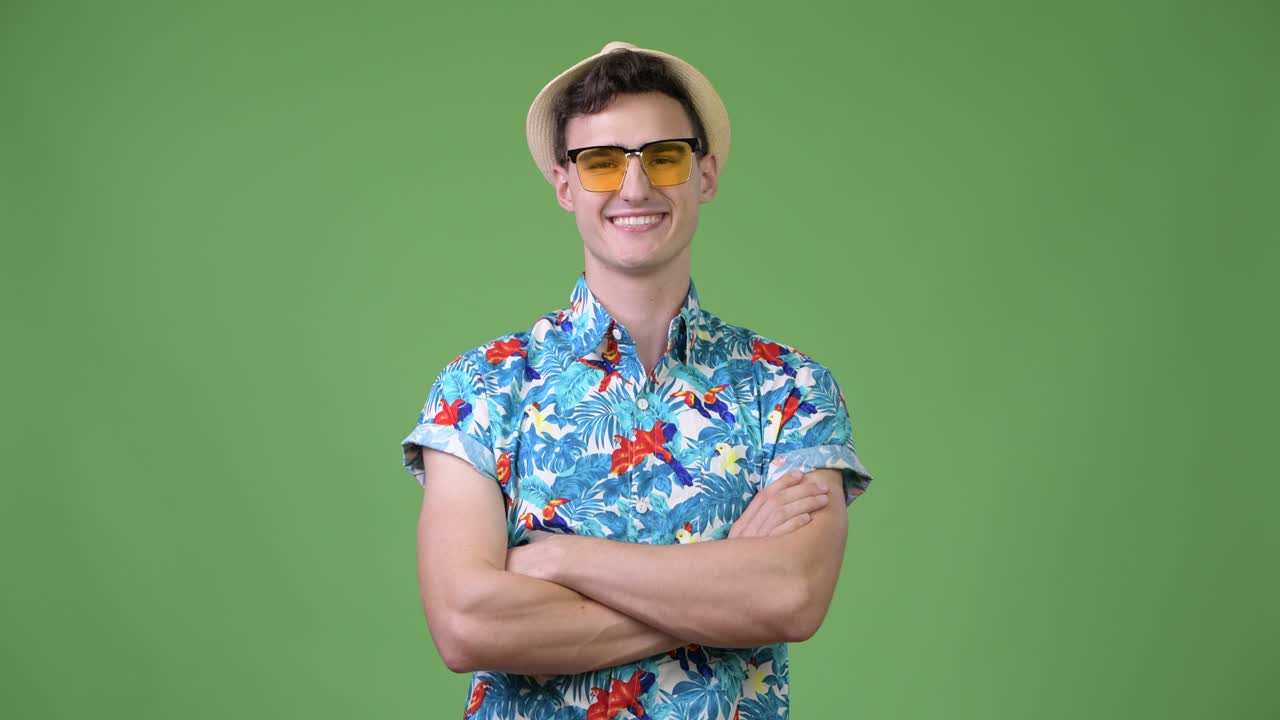 Young handsome tourist man with arms crossed