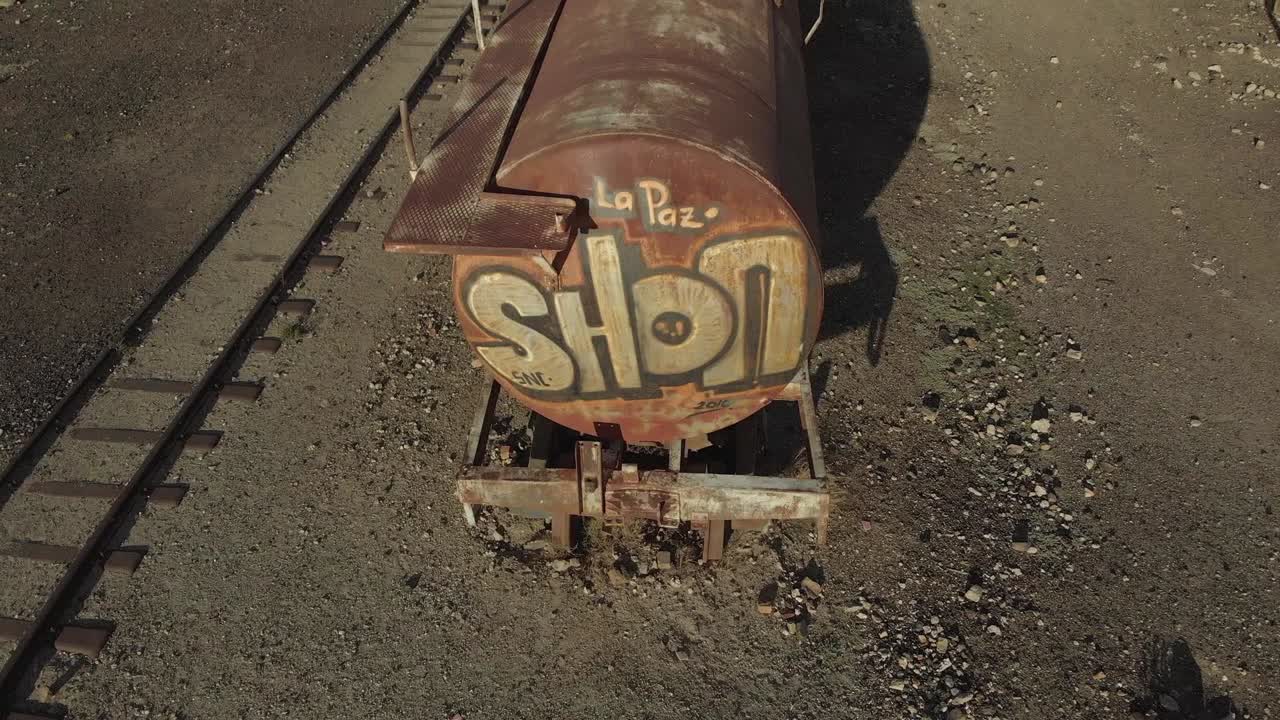 La Paz graffiti on abandoned rusty rail tanker car in Atacama Desert